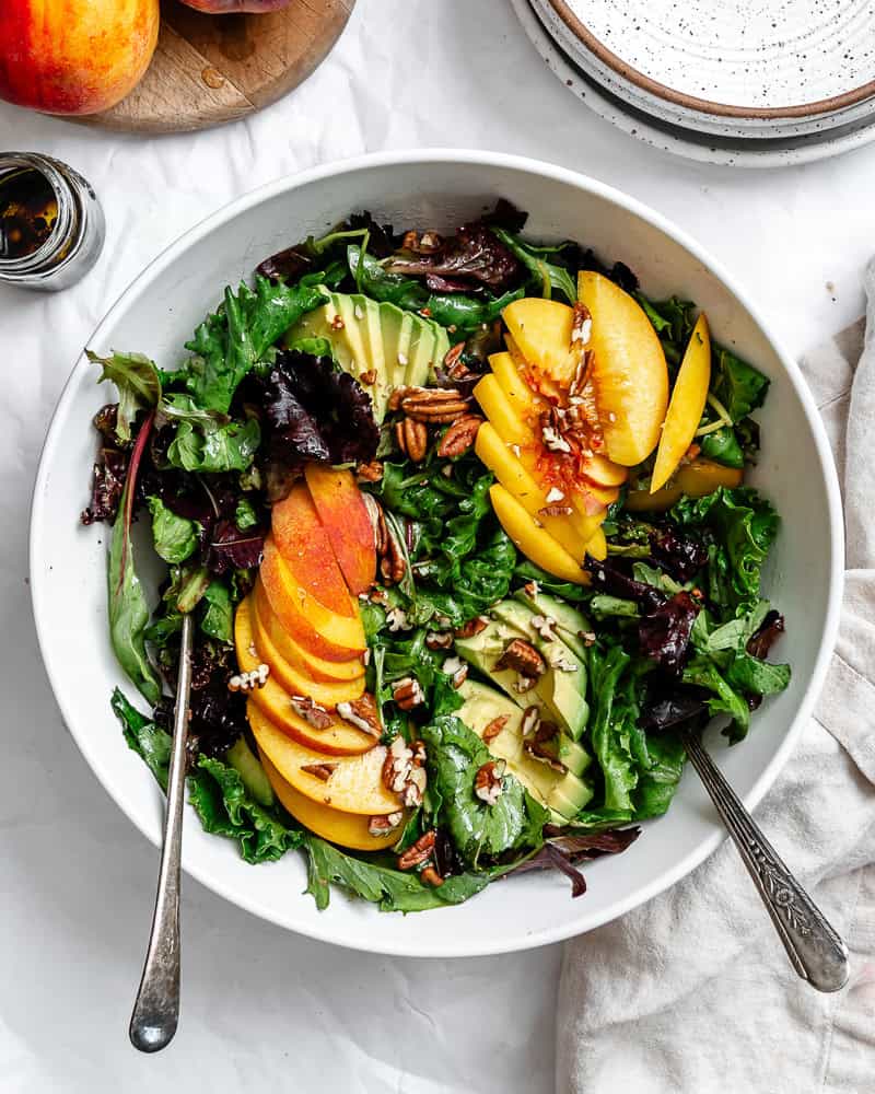 a peach salad in a large white bowl.