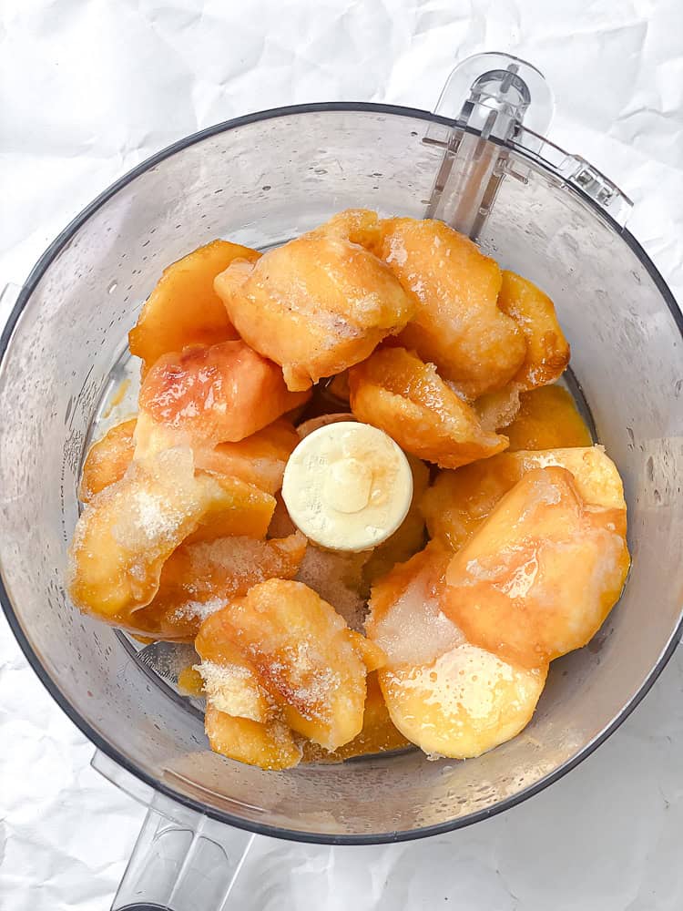 frozen peach slices in a food processor.