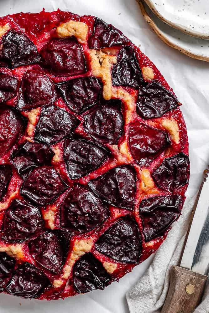 completed Easy Plum Cake on a white surface