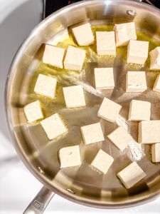 process shot of tofu cooking in pan