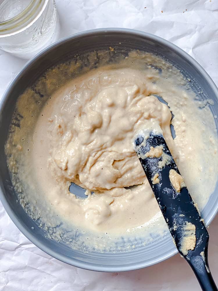 process shot showing mixing tahini mixture in bowl