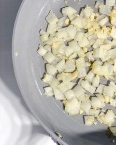 process shot showing veggies cooking in pan