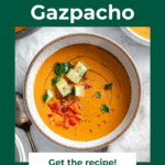 Pinterest pin of Watermelon Gazpacho in a white bowl with chopped cucumber, basil, and red peppers on top.