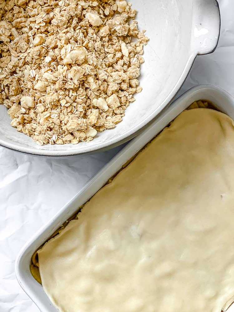 process shot showing topping alongside baking dish 