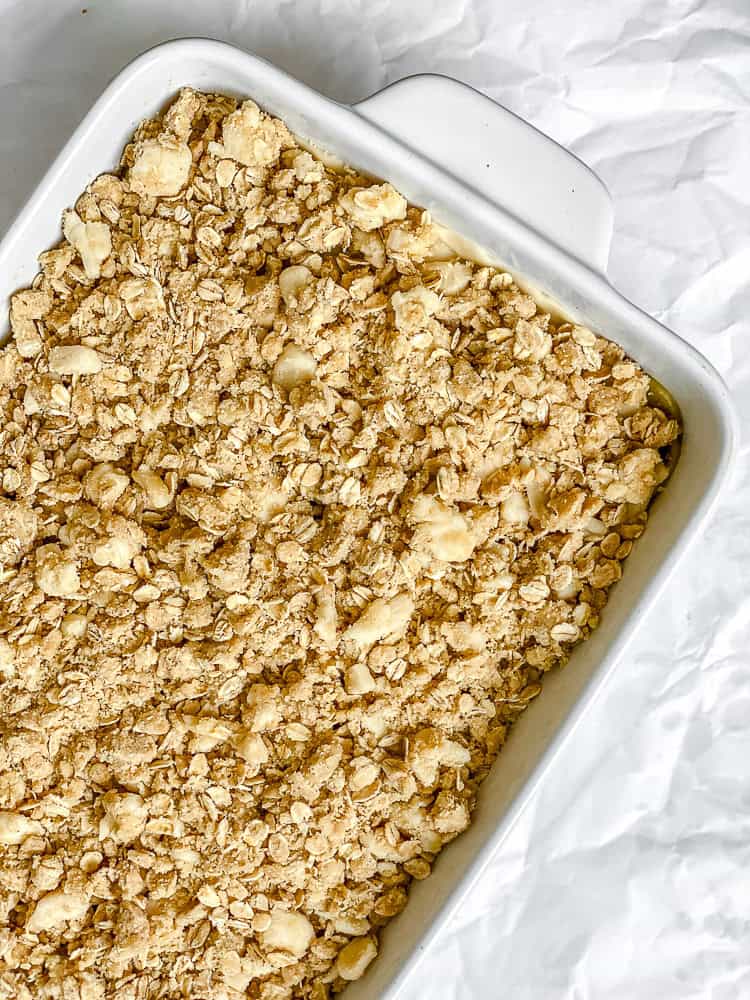 process shot showing apple pie bar mixture in baking dish