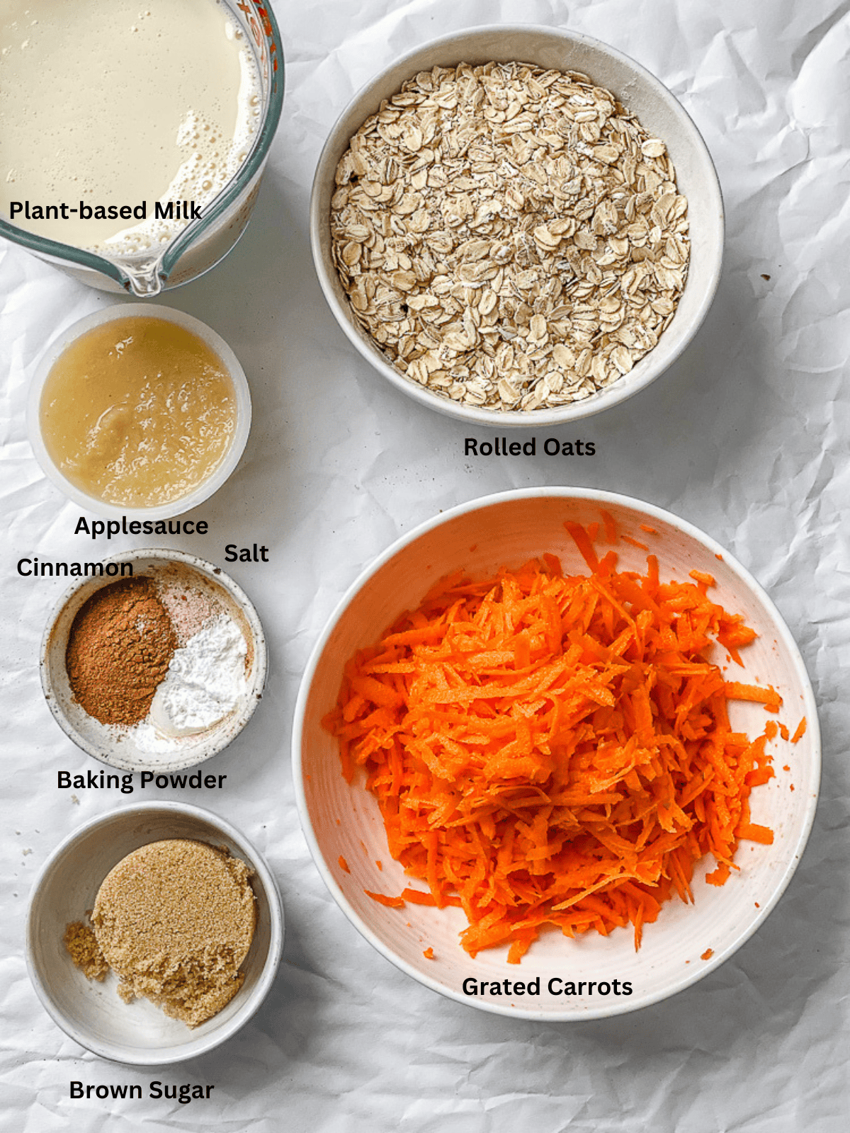 ingredients for Carrot Cake Baked Oats measured out on a white surface