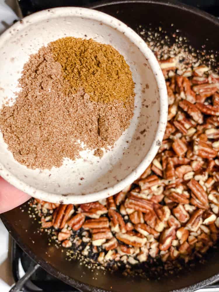 process shot showing spices being added to pan