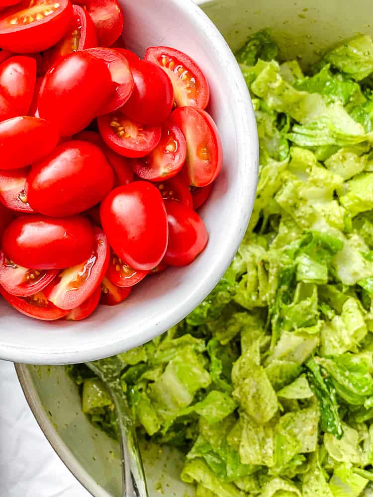 process shot of adding tomatoes to salad