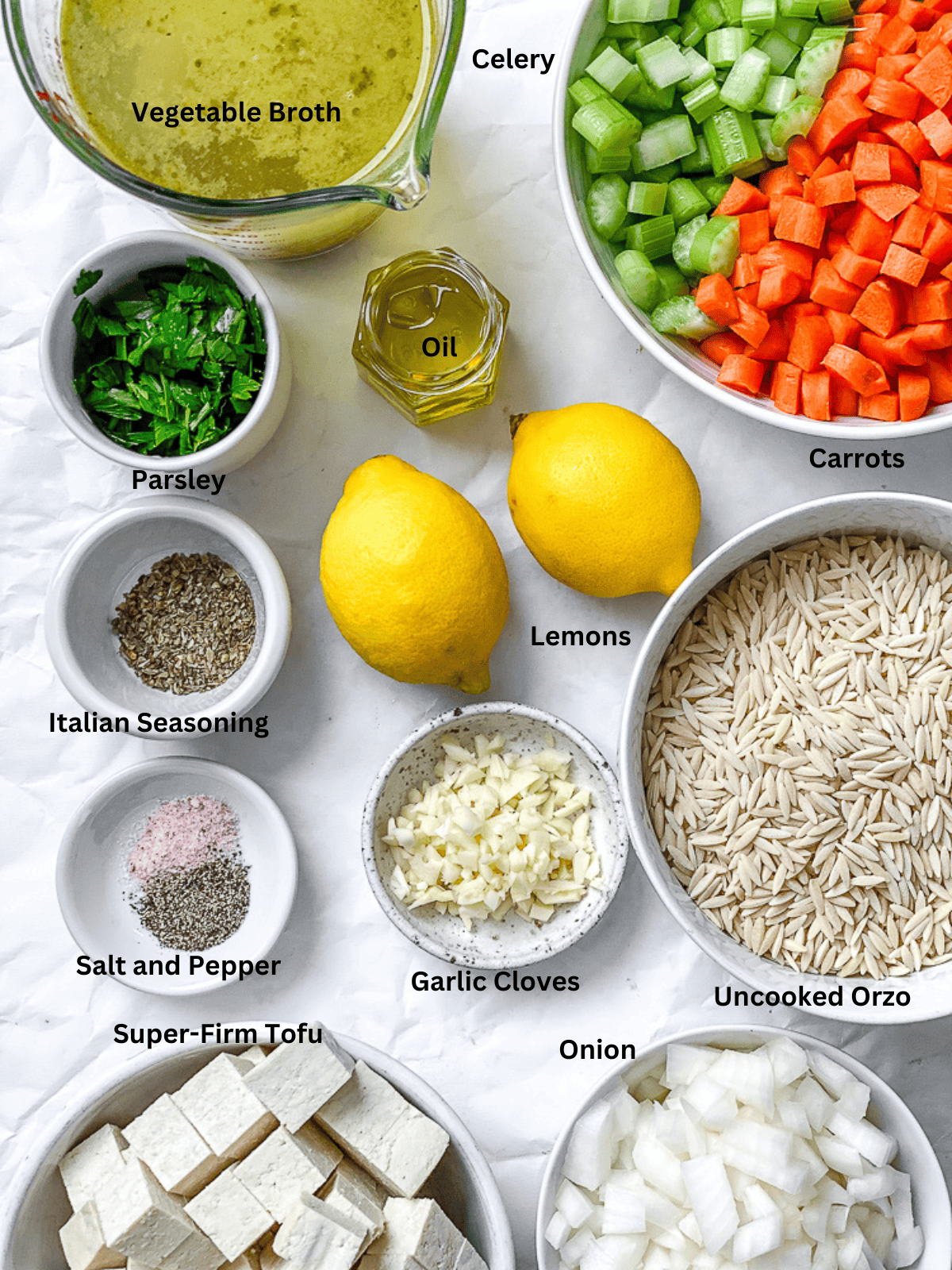 ingredients for Lemon Orzo Soup measured out ona. white surface