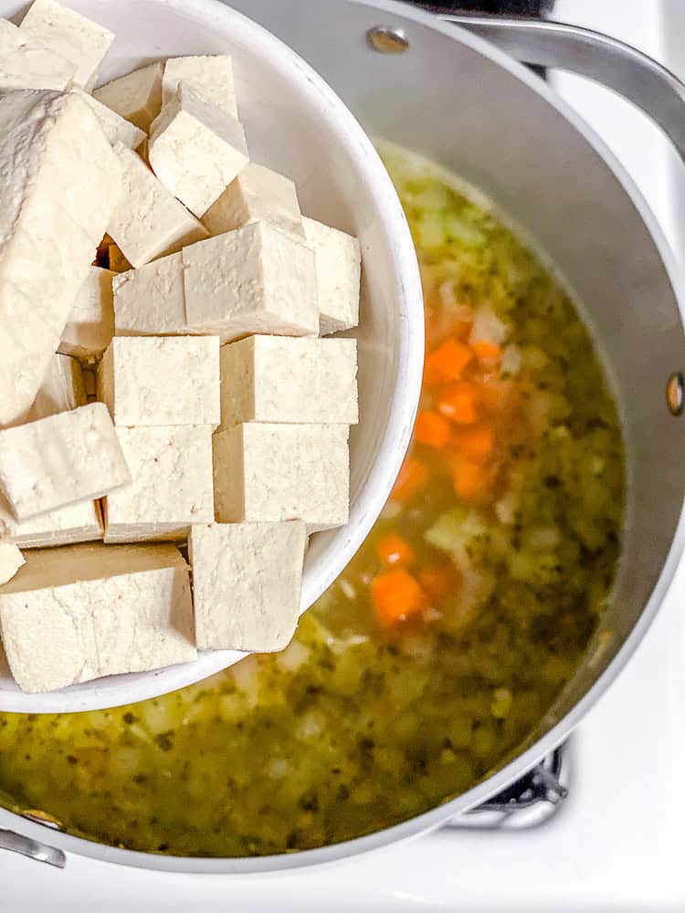 process shot showing adding tofu to pot