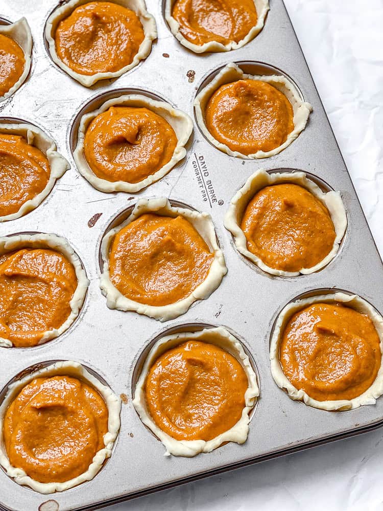 process shot showing pumpkin mixture added to muffin tin