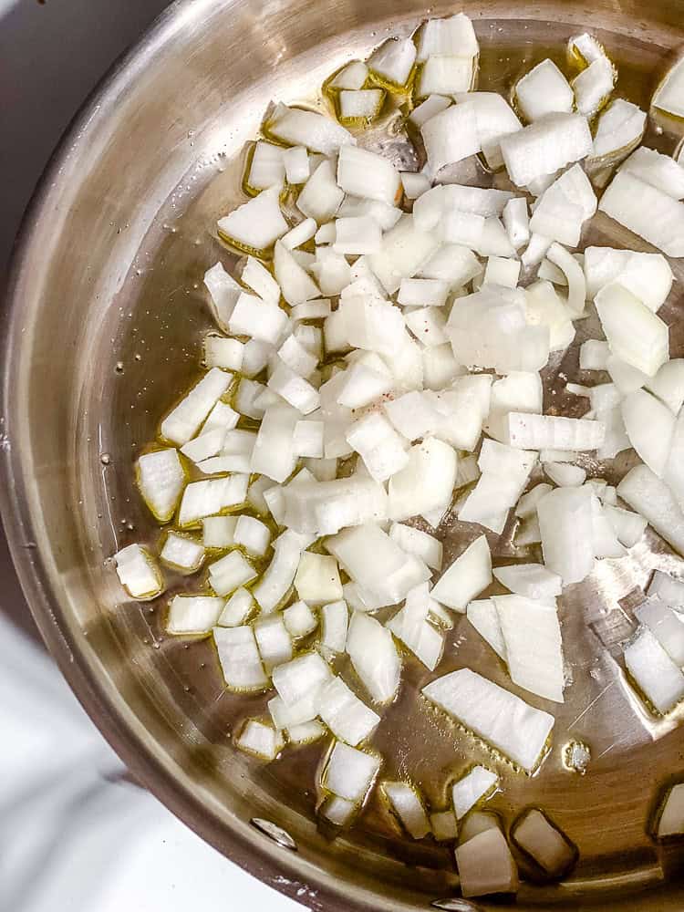 process shot showing onions cookin in pan