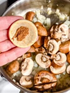 process shot showing adding spices to pan
