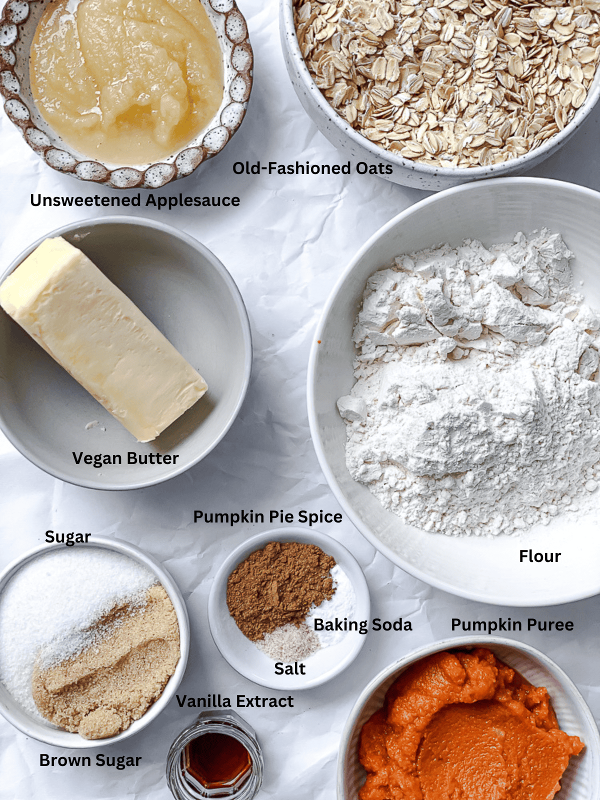 ingredients for Pumpkin Oatmeal Cookies measured out on a white surface