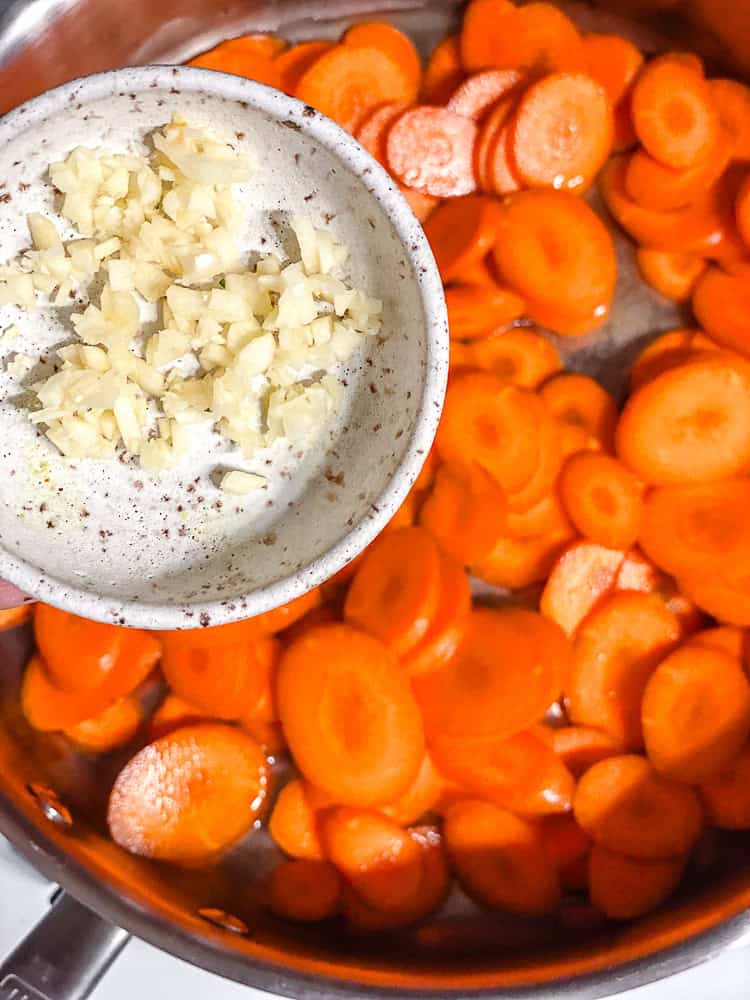 process shot of adding garlic to pan