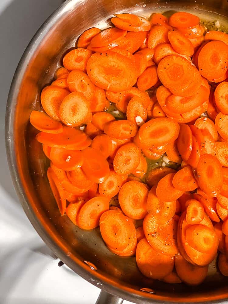 process shot of carrots cooking in pan