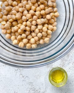 chickpeas in a bowl alongside oil