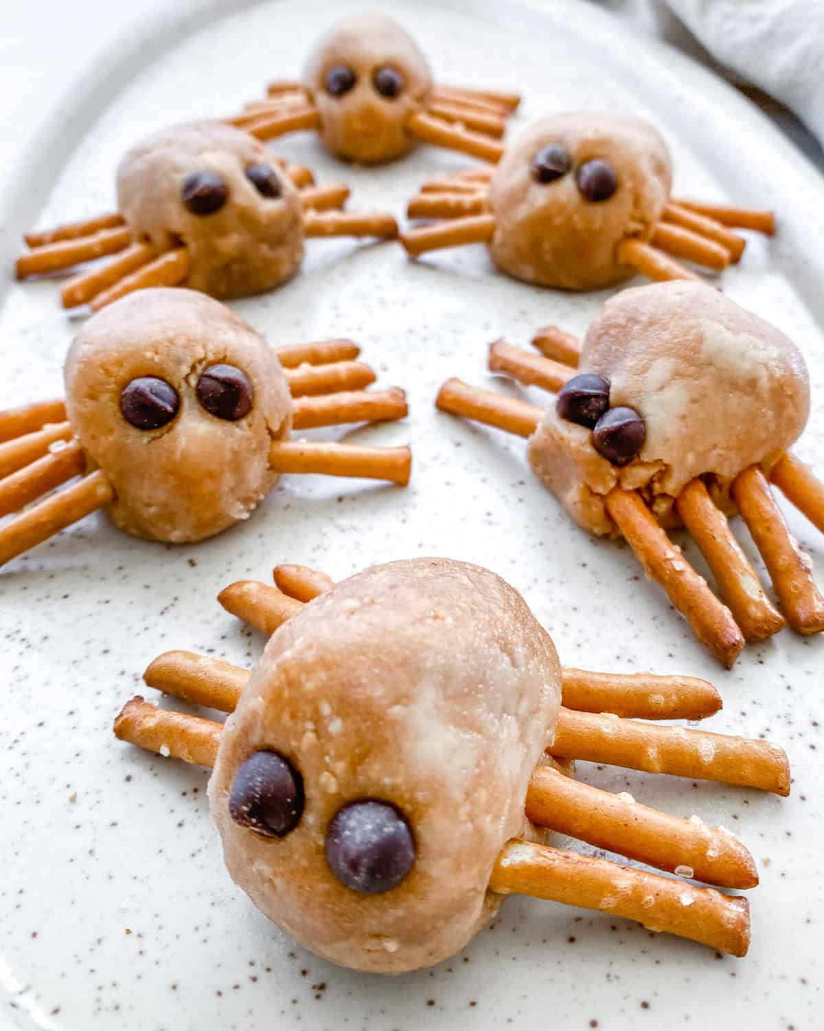 completed Halloween Peanut Butter Spiders on a white platter