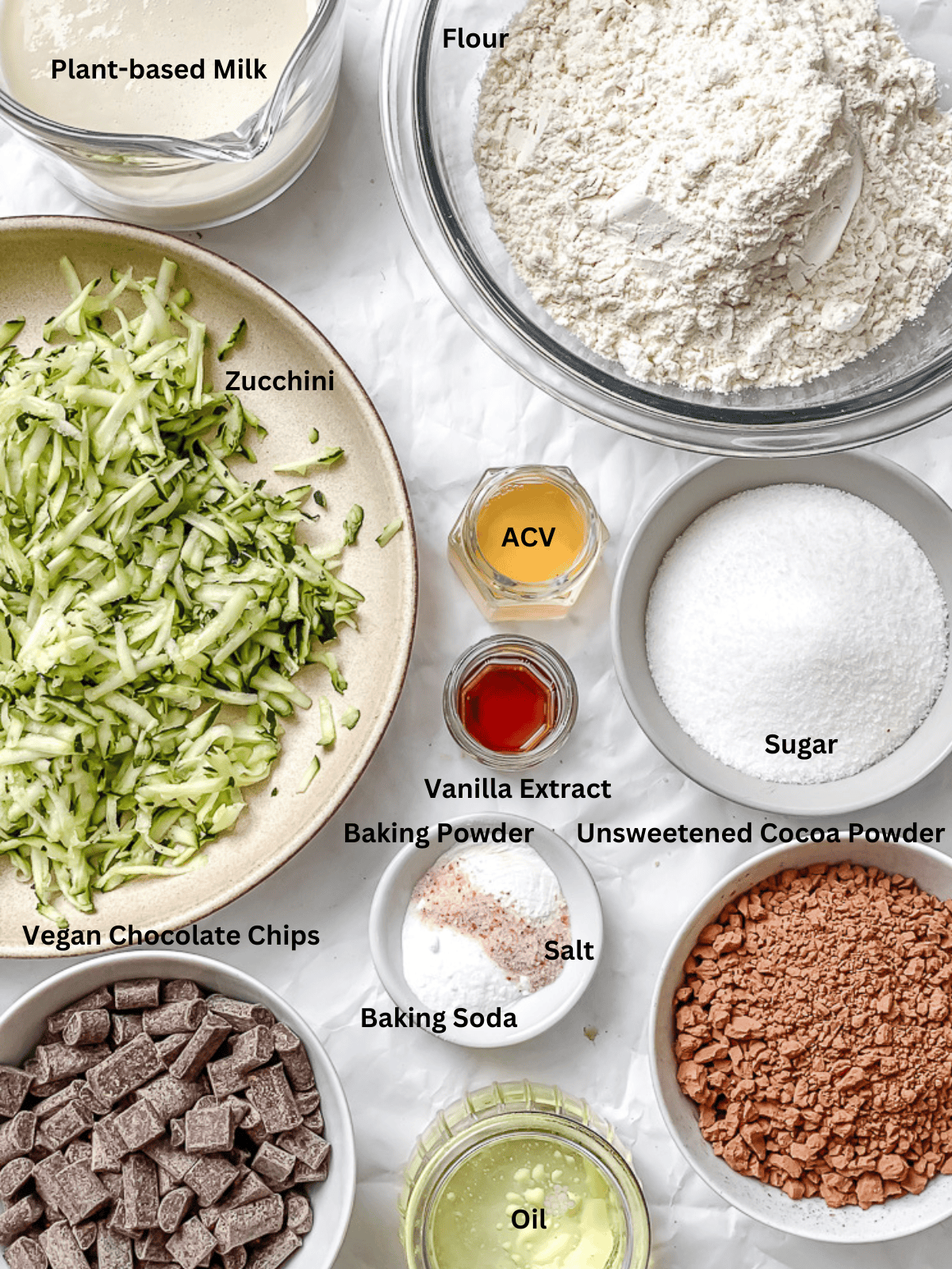 ingredients for Chocolate Zucchini Cake measured out on a white surface