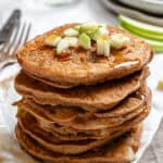 completed stack of Apple Cinnamon Pancakes on a white surface