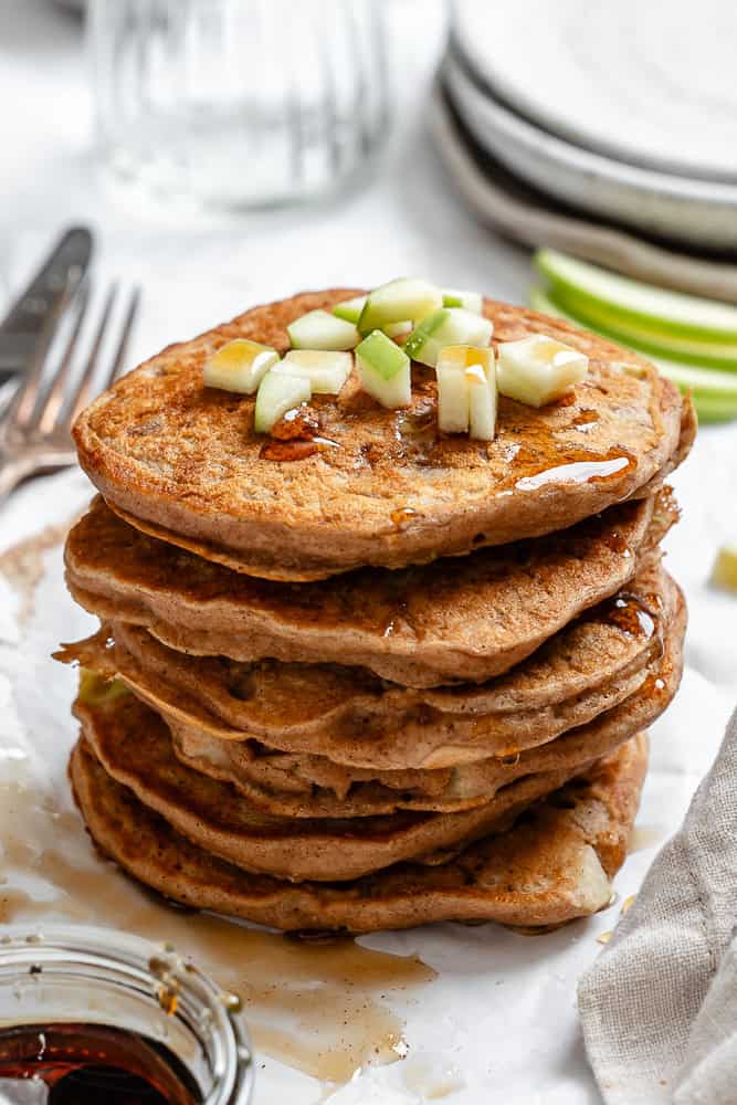 completed stack of Apple Cinnamon Pancakes on a white surface