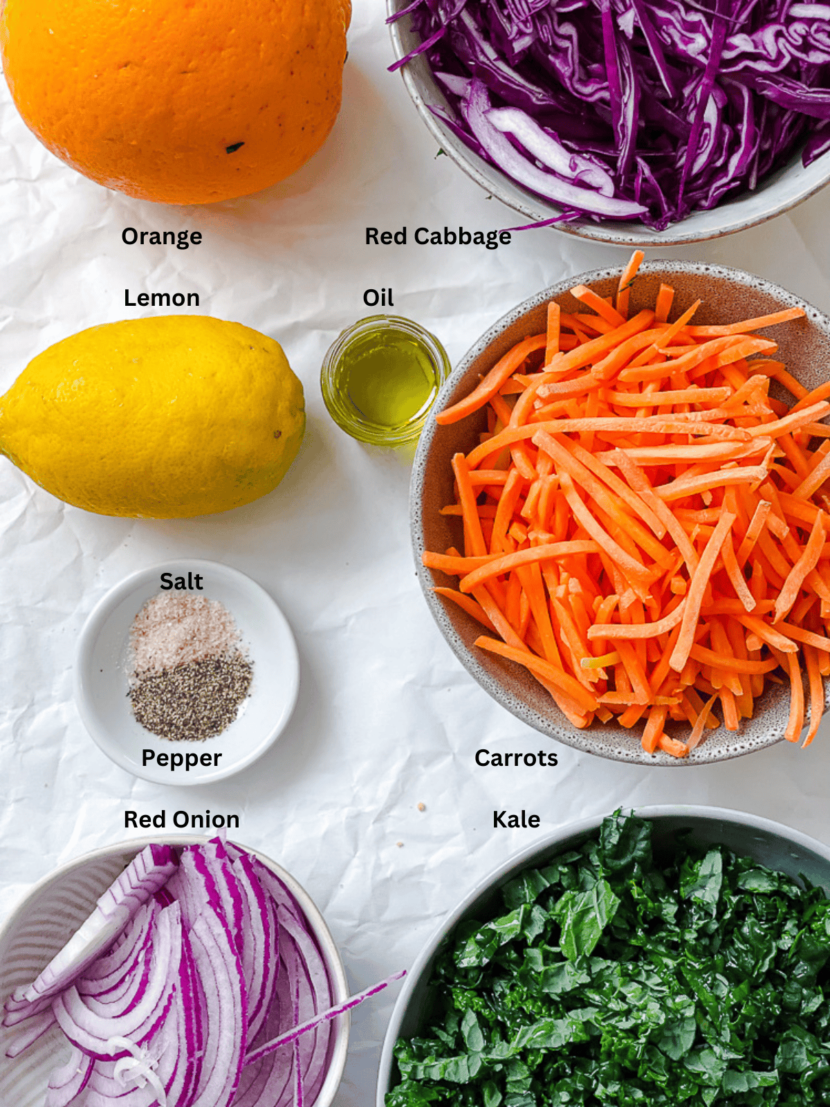 ingredients for Crunchy Kale Slaw measured out on a white surface