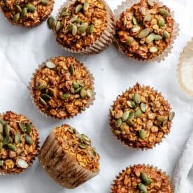 completed Pumpkin Oatmeal Muffins on a white surface