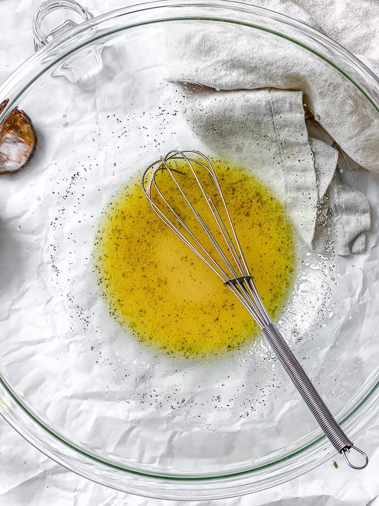 process shot showing whisking dressing in bowl