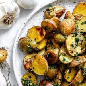 completed Garlic Roasted Baby Potatoes on a plate