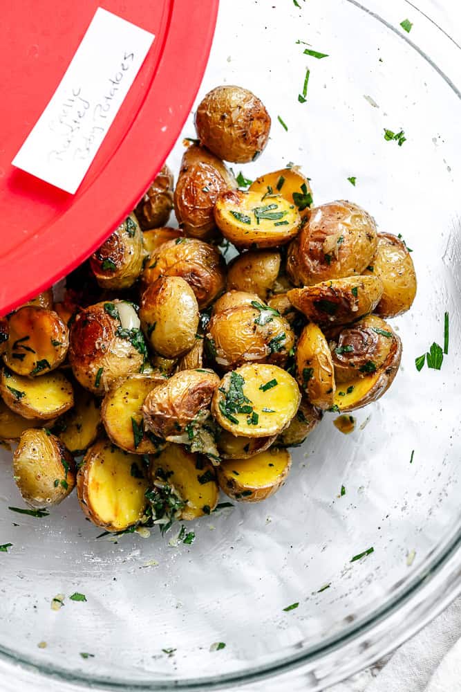 Leftover garlic roasted baby potatoes in a storage container.