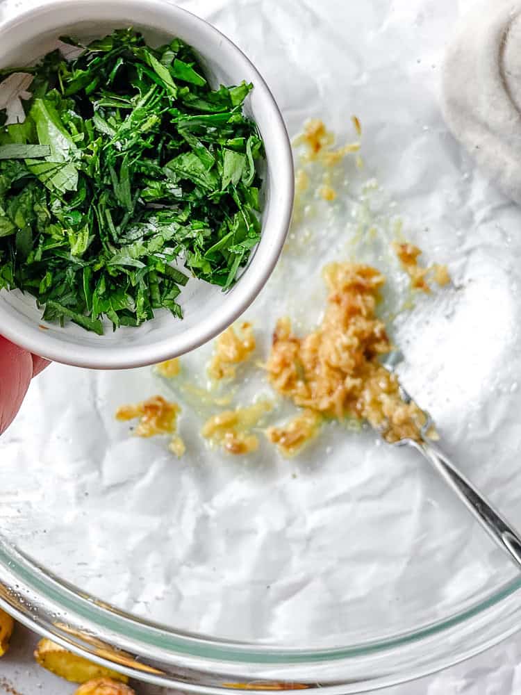 process shot showing adding parsley to bowl