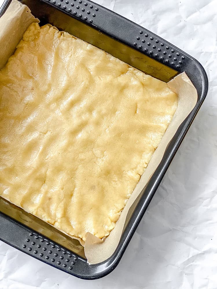 process shot showing crust added to baking dish