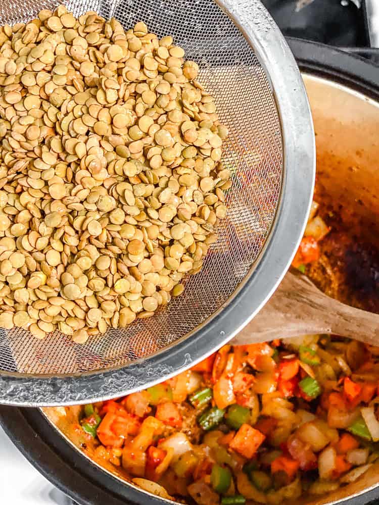 process shot of adding lentils to pot