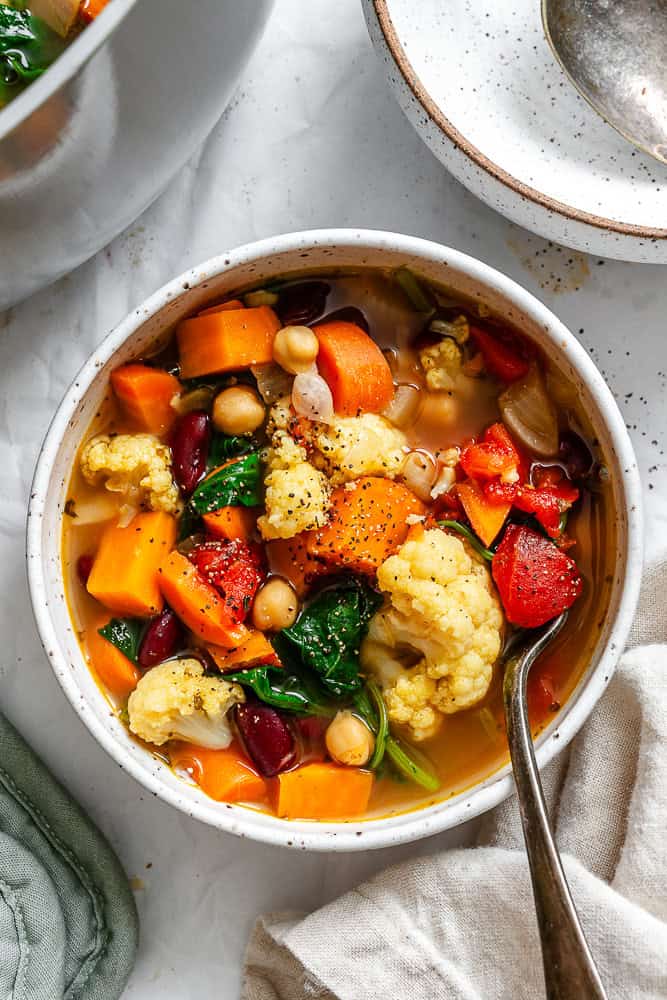 completed Kale Vegetable Bean Soup on a white surface