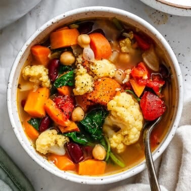 completed Kale Vegetable Bean Soup on a white surface