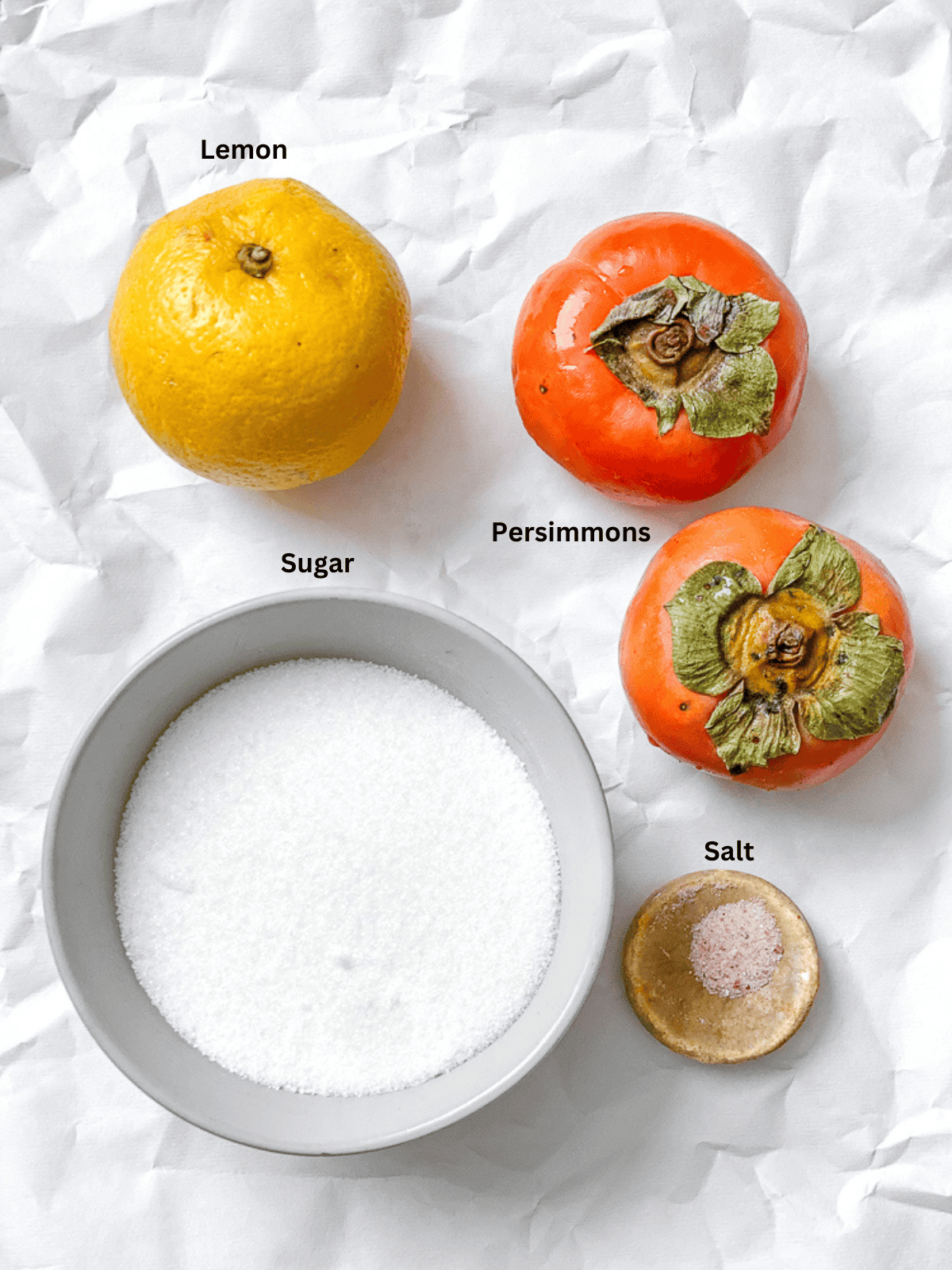 ingredients for Easy Persimmon Jam measured out on a white surface