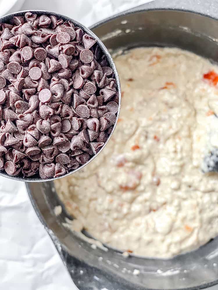 process shot showing adding vegan chocolate chips to bowla