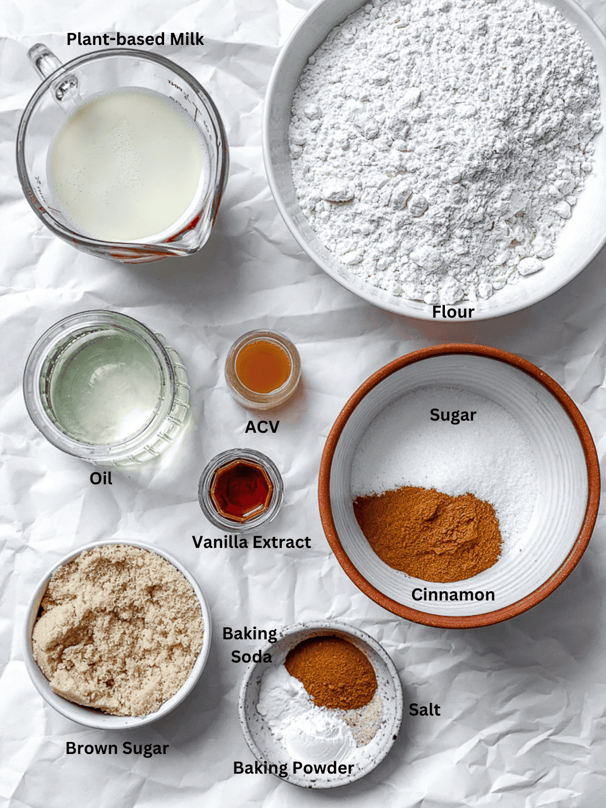 ingredients for Easy Cinnamon Muffins measured out on a white surface