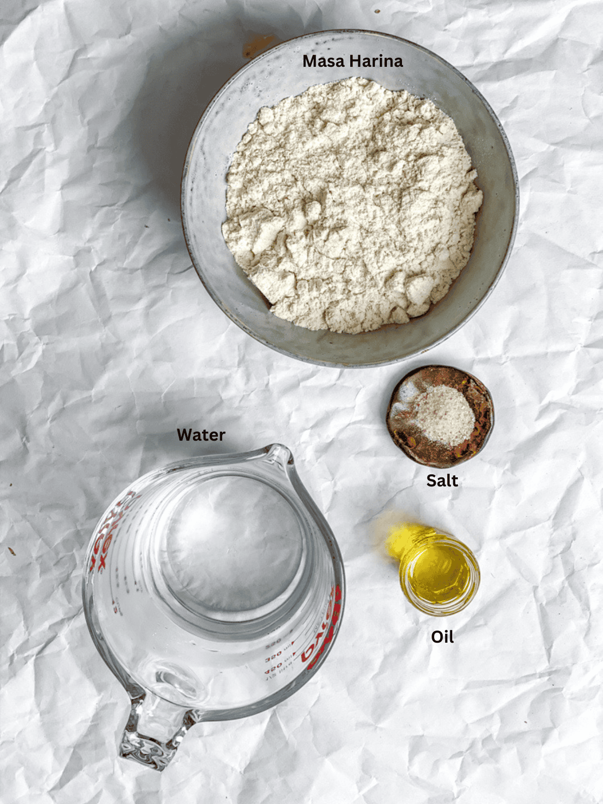 ingredients for Homemade Corn Tortillas measured out on a white surface
