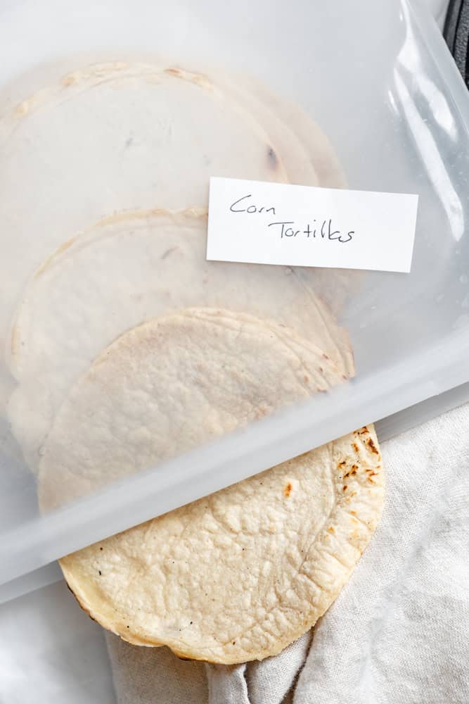 completed Homemade Corn Tortillas in a stroage container