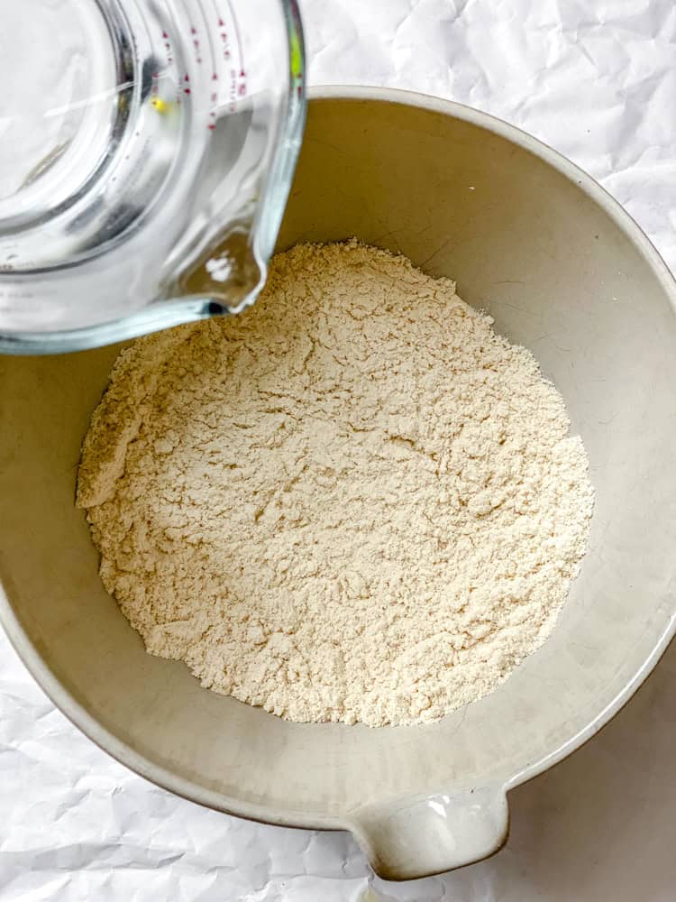 process shot of adding water to mixing bowl
