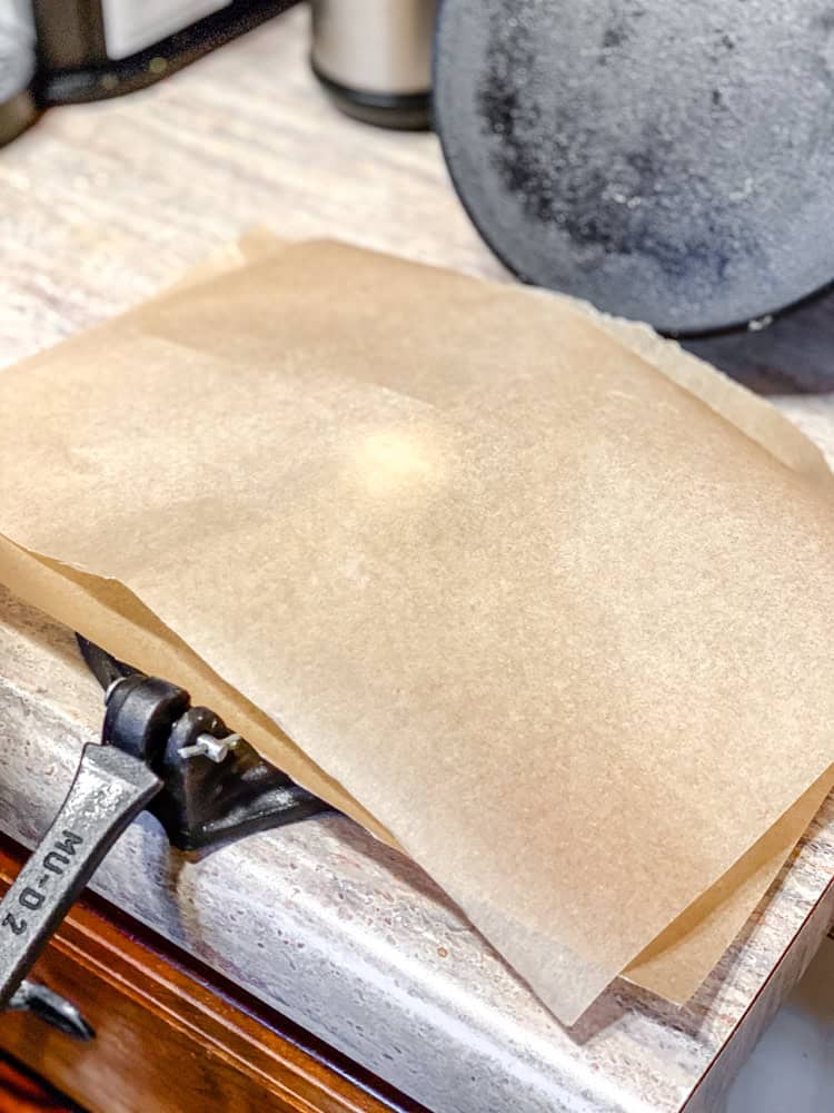 process shot showing dough inbetween parchment paper