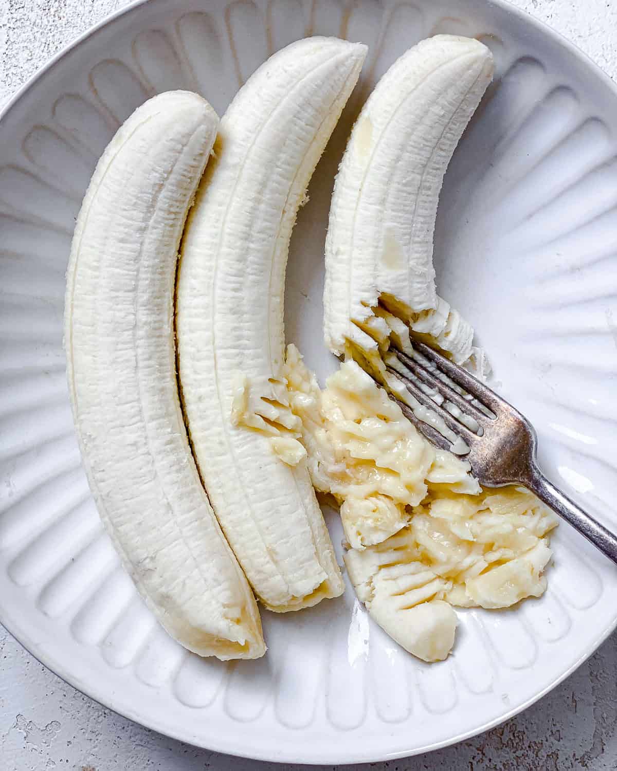 process shot showing mashing bananas with fork