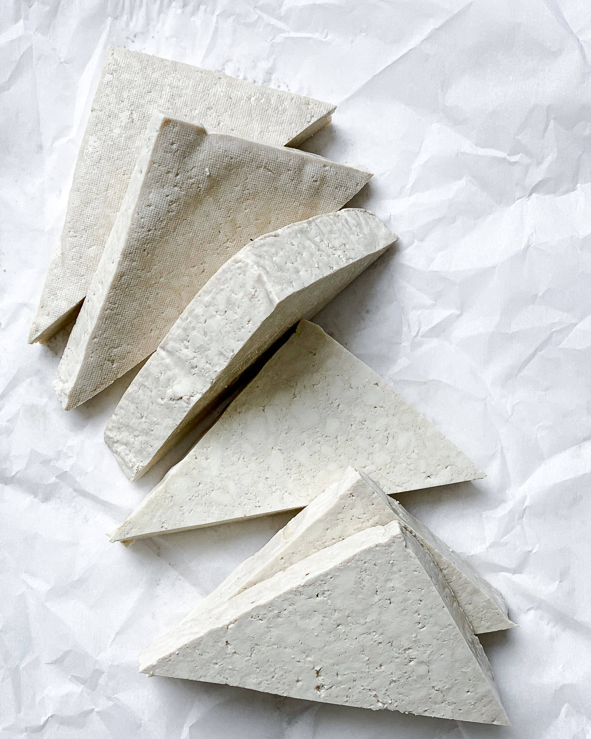 process shot showing sliced tofu on a white surface