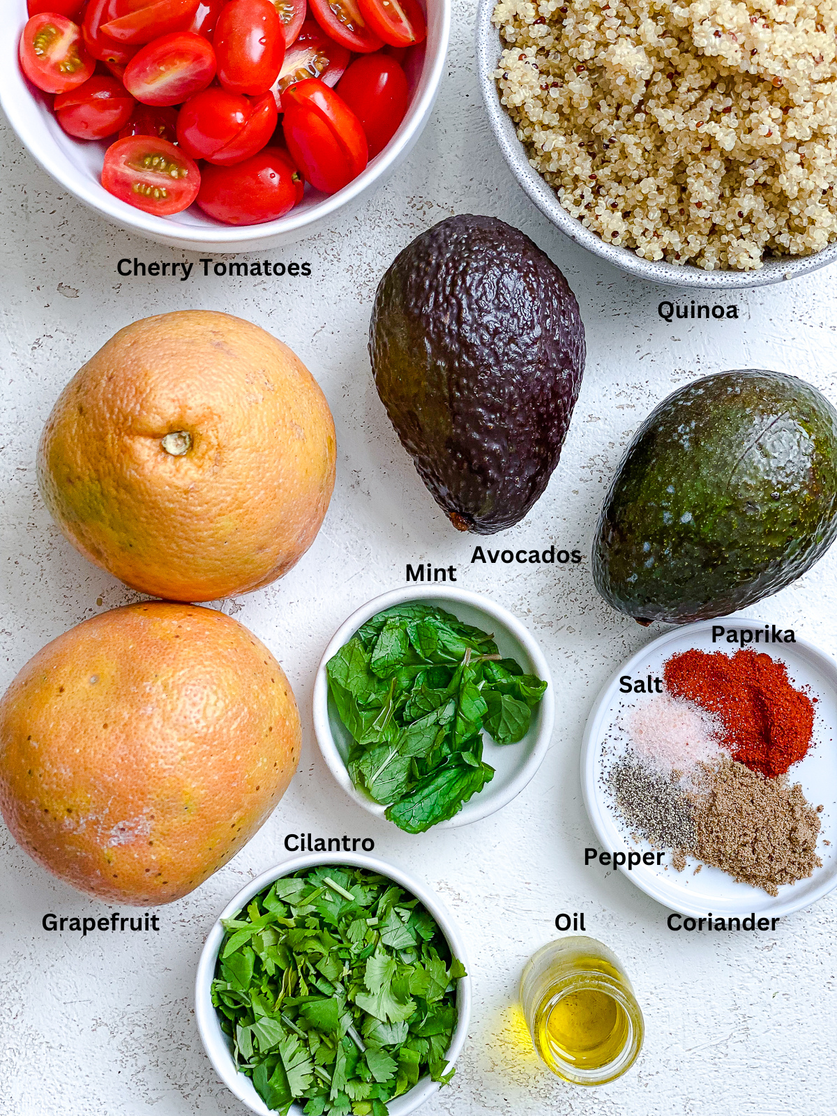 Ingredients for Avocado Quinoa Salad [With Grapefruit] measured out on a white surface.