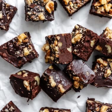 vegan chocolate walnut fudge squares arranged on a white surface
