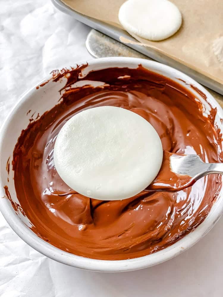 process shot showing dipping Vegan Peppermint Patties in vegan chocolate