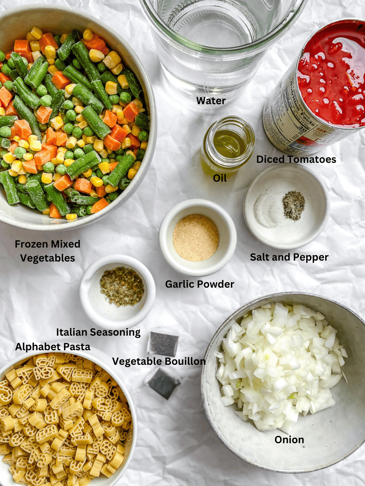 ingredients for Alphabet Soup measured out ona. white surface