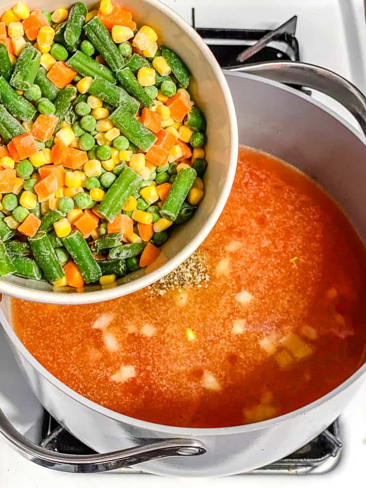 process shot showing adding veggies to pot