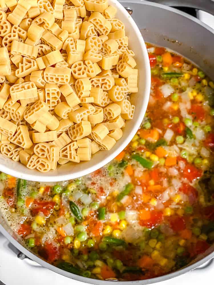process shot showing adding pasta to pan
